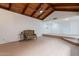 Wide angle view of the living room featuring a wood paneled vaulted ceiling and wood burning fireplace at 405 E Stanford Ave, Gilbert, AZ 85234