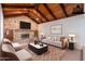 Beautiful living room features a stone fireplace, wood ceiling, and cozy seating at 405 E Stanford Ave, Gilbert, AZ 85234