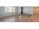 Spacious living room with wood floors, a large window, and front door at 405 E Stanford Ave, Gilbert, AZ 85234