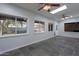 Bright living room featuring windows, ceiling fans, tile flooring, and direct backyard views at 405 E Stanford Ave, Gilbert, AZ 85234