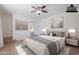 Bright primary bedroom featuring large bed, ceiling fan, and natural light at 405 E Stanford Ave, Gilbert, AZ 85234