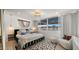 A stylish bedroom features a window with natural light, a comfortable chair, and modern decor at 4411 N 40Th St # 40, Phoenix, AZ 85018