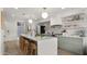 Modern kitchen featuring a quartz waterfall island, stylish light fixtures, and stainless steel appliances for the discerning chef at 4411 N 40Th St # 40, Phoenix, AZ 85018