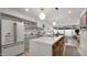 Sunlit kitchen with island seating, open shelving, and stainless steel appliances for the ultimate cooking experience at 4411 N 40Th St # 40, Phoenix, AZ 85018