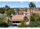 Aerial view of a desert home featuring a tile roof, palm trees, and professional desert landscaping at 4625 E Villa Maria Dr, Phoenix, AZ 85032