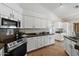 Bright kitchen featuring white cabinetry, granite countertops, and stainless steel appliances, offering a modern and functional space at 4625 E Villa Maria Dr, Phoenix, AZ 85032