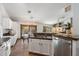 Open-concept kitchen with granite countertops, stainless steel appliances, and a view to the dining area and backyard at 4625 E Villa Maria Dr, Phoenix, AZ 85032