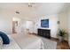 Comfortable bedroom with plush carpeting, a minimalist console table, a ceiling fan, and a doorway to another room at 4625 E Villa Maria Dr, Phoenix, AZ 85032