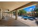 Covered patio and outdoor barbecue area with desert landscaping and a beautiful pool and spa at 4625 E Villa Maria Dr, Phoenix, AZ 85032