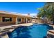 Backyard pool and spa featuring a covered patio and outdoor barbecue area at 4625 E Villa Maria Dr, Phoenix, AZ 85032