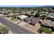 An aerial view showcasing the property, surrounding homes, palm trees, and desert landscape at 4913 E Acoma Dr, Scottsdale, AZ 85254