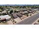 Aerial view of a well-maintained home with desert landscaping, manicured lawns, and mature trees at 4913 E Acoma Dr, Scottsdale, AZ 85254