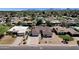 Aerial view of the home featuring desert landscaping, nearby mountains, and a well-maintained lawn at 4913 E Acoma Dr, Scottsdale, AZ 85254