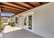 Backyard exterior showing a covered patio and French door access to the interior at 4913 E Acoma Dr, Scottsdale, AZ 85254