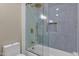 Modern bathroom showing a shower with gold hardware and unique blue tiled walls at 4913 E Acoma Dr, Scottsdale, AZ 85254