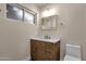 Bathroom featuring marble countertops, vanity with wood cabinets, and gold hardware at 4913 E Acoma Dr, Scottsdale, AZ 85254