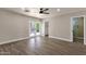 Bedroom showcasing wood-look floors, a ceiling fan, and a closet with adjacent bathroom access at 4913 E Acoma Dr, Scottsdale, AZ 85254