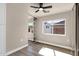 Well-lit bedroom showing a ceiling fan, sliding mirror closet doors, and outdoor views at 4913 E Acoma Dr, Scottsdale, AZ 85254