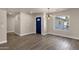 Bright entryway with wood-look tile, striking blue door, and stylish light fixture at 4913 E Acoma Dr, Scottsdale, AZ 85254