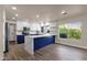Bright kitchen with white cabinets, custom island, stone countertops, and new appliances at 4913 E Acoma Dr, Scottsdale, AZ 85254