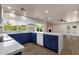 Bright kitchen boasts blue cabinets, stainless appliances, ample counter space, and natural light at 4913 E Acoma Dr, Scottsdale, AZ 85254