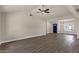 Open floor plan features wood-look tile flooring, ceiling fan, and front door view at 4913 E Acoma Dr, Scottsdale, AZ 85254