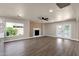 Large, bright living room with modern fireplace and access to the pool area at 4913 E Acoma Dr, Scottsdale, AZ 85254