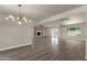 Open floor plan boasts wood-look tile, modern lighting, and access to the outdoor space at 4913 E Acoma Dr, Scottsdale, AZ 85254