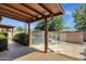 View of covered patio looking out to fenced pool area with landscaping, block fencing, and tile flooring at 4913 E Acoma Dr, Scottsdale, AZ 85254