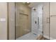 Elegant walk-in shower featuring gold fixtures and marble accents at 4913 E Acoma Dr, Scottsdale, AZ 85254