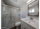 This modern bathroom features a new vanity, mirror, and glass shower door at 5336 W Lewis Ave, Phoenix, AZ 85035