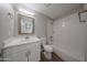 Bathroom features updated vanity, white cabinets and tub with shower at 5336 W Lewis Ave, Phoenix, AZ 85035