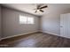 Bedroom with hardwood floors, ceiling fan, neutral paint and natural light from window at 5336 W Lewis Ave, Phoenix, AZ 85035