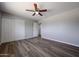 The spacious bedroom offers new wood-look floors, a ceiling fan, and double closets at 5336 W Lewis Ave, Phoenix, AZ 85035