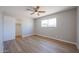 Bedroom with laminate flooring, neutral gray walls, and standard closet at 5336 W Lewis Ave, Phoenix, AZ 85035