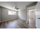 Bright bedroom showcasing modern flooring, a ceiling fan, and a hallway entrance at 5336 W Lewis Ave, Phoenix, AZ 85035