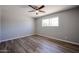 This bedroom offers a ceiling fan, wood-look flooring, and a window for lots of natural light at 5336 W Lewis Ave, Phoenix, AZ 85035