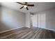 Cozy bedroom with wood floors, a ceiling fan, and a closet at 5336 W Lewis Ave, Phoenix, AZ 85035