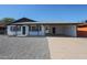 Charming single-story home featuring a gravel front yard, covered porch, and attached carport at 5336 W Lewis Ave, Phoenix, AZ 85035