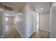 Bright hallway featuring wood floors, neutral walls, and a closet with white sliding doors at 5336 W Lewis Ave, Phoenix, AZ 85035