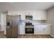 Updated kitchen showcasing stainless steel appliances and sleek white cabinetry with plenty of space at 5336 W Lewis Ave, Phoenix, AZ 85035