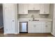 New stainless steel dishwasher and faucet against a backdrop of white cabinets and countertops at 5336 W Lewis Ave, Phoenix, AZ 85035