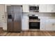 Updated kitchen showcasing stainless steel appliances and white cabinetry at 5336 W Lewis Ave, Phoenix, AZ 85035