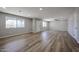 Bright living room with light gray walls, wood flooring, and ample natural light at 5336 W Lewis Ave, Phoenix, AZ 85035