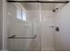 Modern shower showcasing glass doors, shelving, and sleek fixtures at 5336 W Lewis Ave, Phoenix, AZ 85035