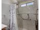 Accessible bathroom with marble-look shower, safety bars, and hand-held shower head at 5621 S 30Th Gln, Phoenix, AZ 85041