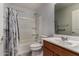This bathroom features a shower and vanity with a mirror at 5621 S 30Th Gln, Phoenix, AZ 85041