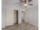 This bedroom features wood look flooring and a closet for storage at 5621 S 30Th Gln, Phoenix, AZ 85041