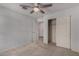 Neutral bedroom featuring plush carpet, ceiling fan, and a large closet at 5621 S 30Th Gln, Phoenix, AZ 85041