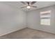 This bedroom features neutral carpet and a ceiling fan for added comfort at 5621 S 30Th Gln, Phoenix, AZ 85041